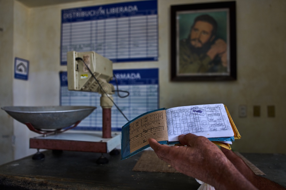 A man shows his ration book known as a 