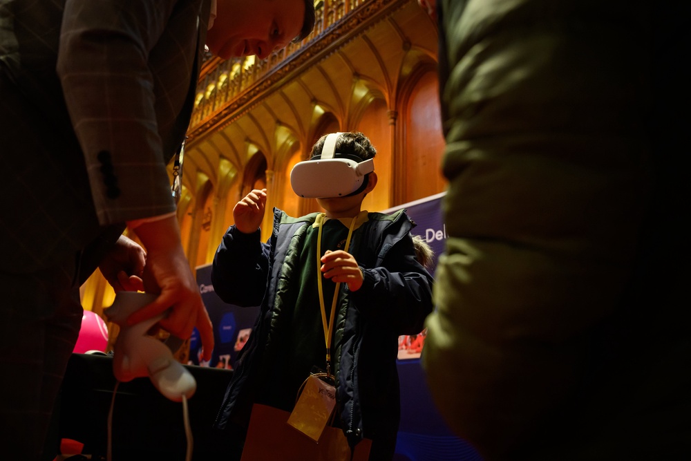Primary school children try on VR headsets as they speak with a representative of Metaverse Learning (Getty)