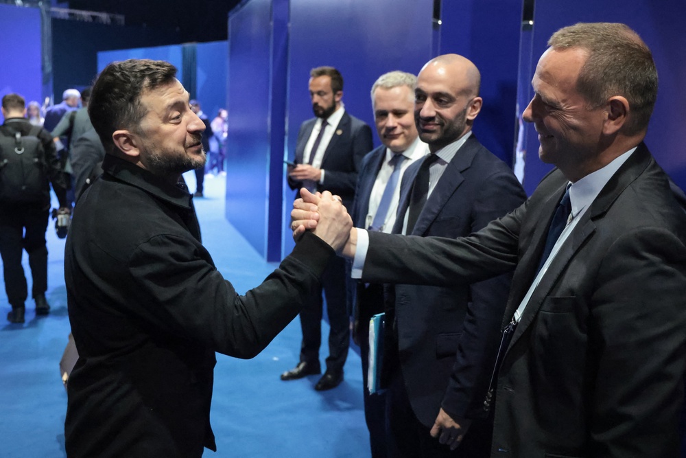 Zelensky and French diplomatic advisor Emmanuel Bonne shake hands (AFP/Getty)