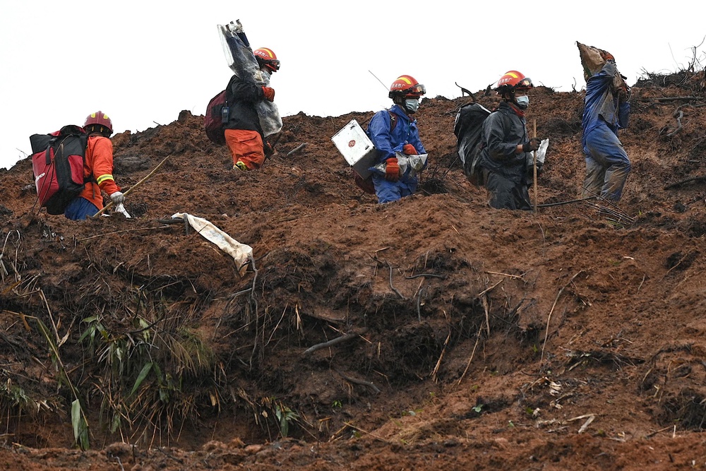 Rescue workers comb through the site where China Eastern flight MU5375 crashed (AFP/Getty)