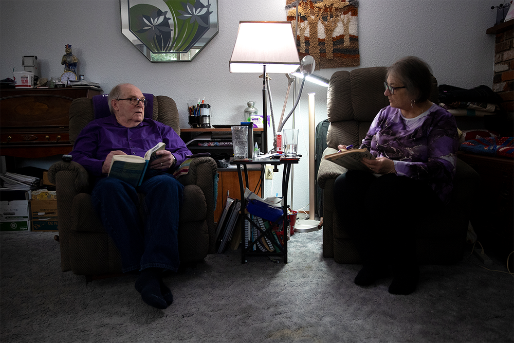 Doug Whitney, left, and his wife work on word puzzles in their home near Seattle (Megan Farmer/WashU Medicine)