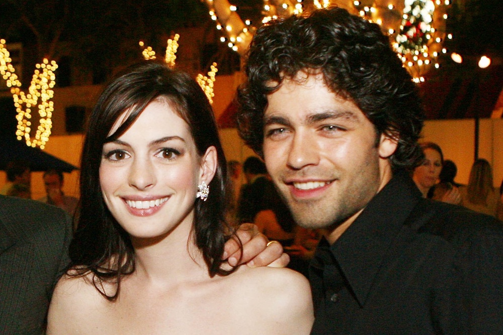 Hathaway (dazzling, brilliant) and Adrian Grenier (straight, evil) attend a ‘Devil Wears Prada’ event in 2006 (Getty)