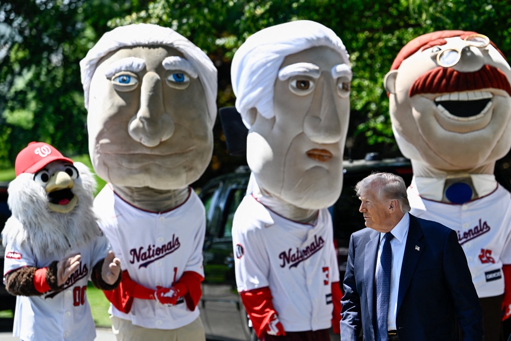 Trump surrounded by a group of mascots in Washington Nationals jerseys (AFP/Getty)