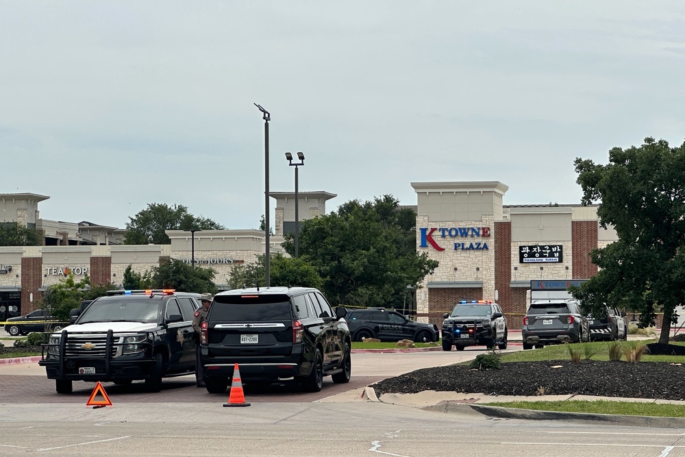 Video posted online showed officers with their guns drawn as they walked past doors at K Towne Plaza in an area of the city known as Koreatown (AP Photo/Jamie Stengle)