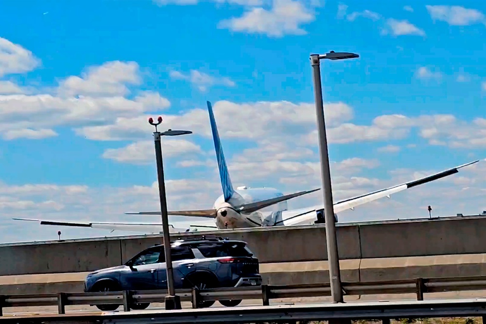 A still image taken from video shows a passenger plane after it hit a light pole and a semitrailer truck on the New Jersey Turnpike while landing at Newark Airport on May 3, 2026 (AP)