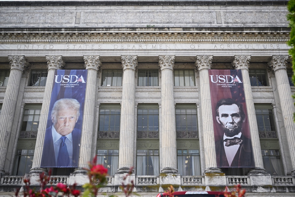 In one of the first moves to add Trump’s likeness to buildings outside of the White House, gigantic banners of his face and former President Abraham Lincoln’s face were hung over the entrance of the Department of Agriculture’s headquarters in D.C. in May 2025 (AFP via Getty Images)