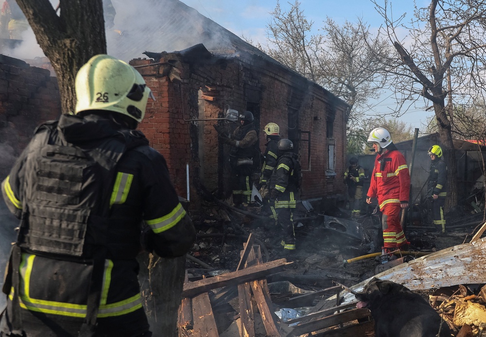 Rescuers douse fire at the site of the private house hit by a Russian drone strike in Kharkiv (Reuters)