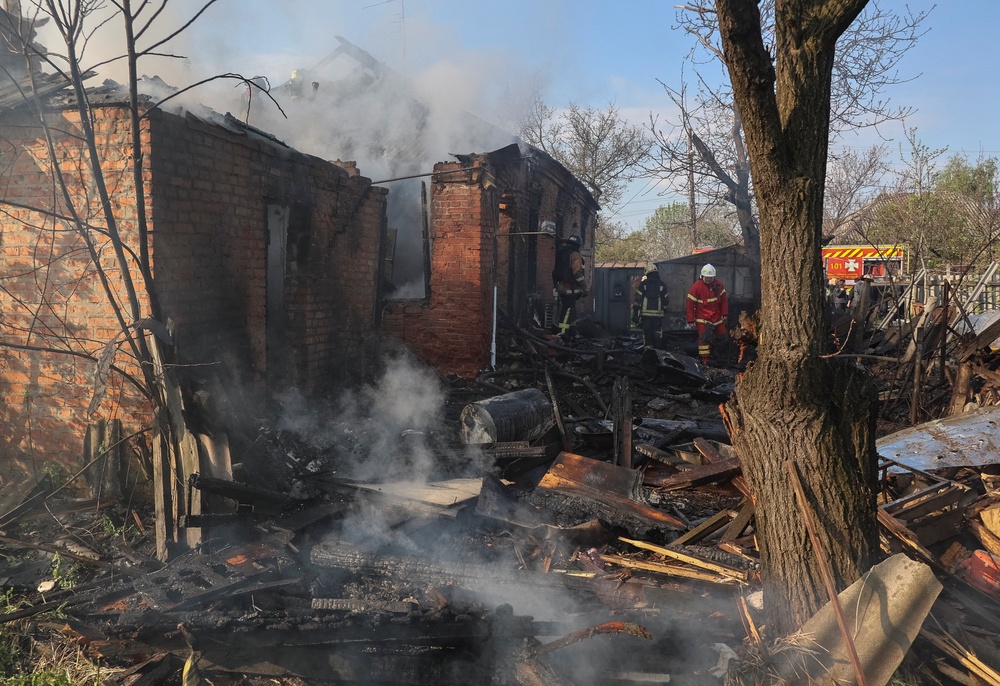 Rescuers work at the site of a private house hit by a Russian drone strike in Kharkiv (Reuters)