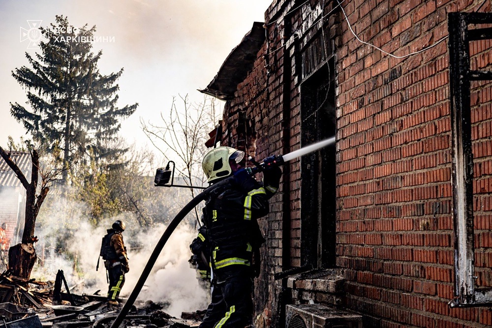 Ukrainian emergency services personnel work to extinguish a fire following a Russian drone attack in Kharkiv region (AP)