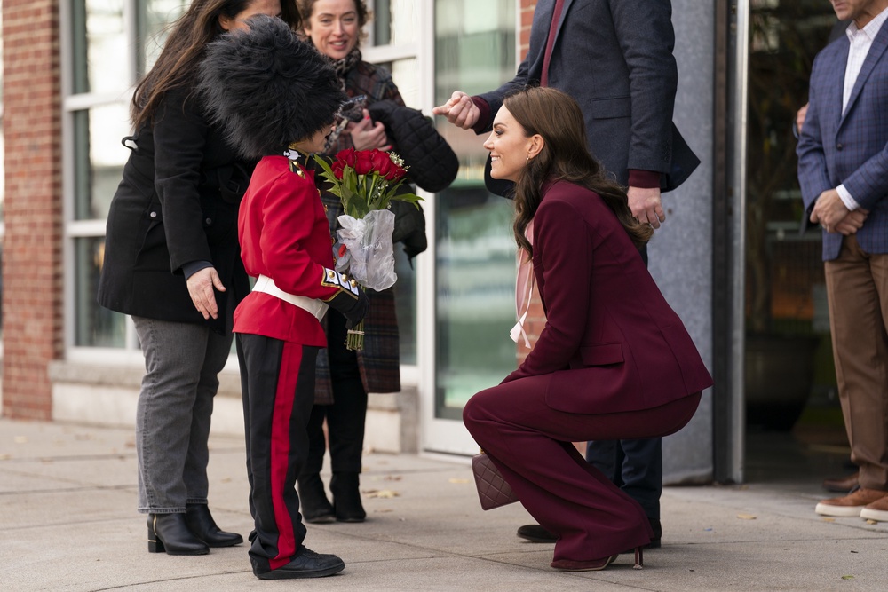 Kate being presented with flowers by an eight-year-old boy dressed as a Guardsman (PA) (PA Archive)