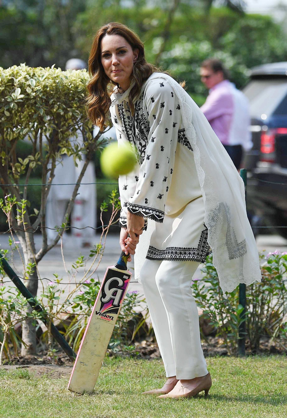 Kate playing cricket during a visit to the SOS Village at Lahore (PA) (PA Archive)
