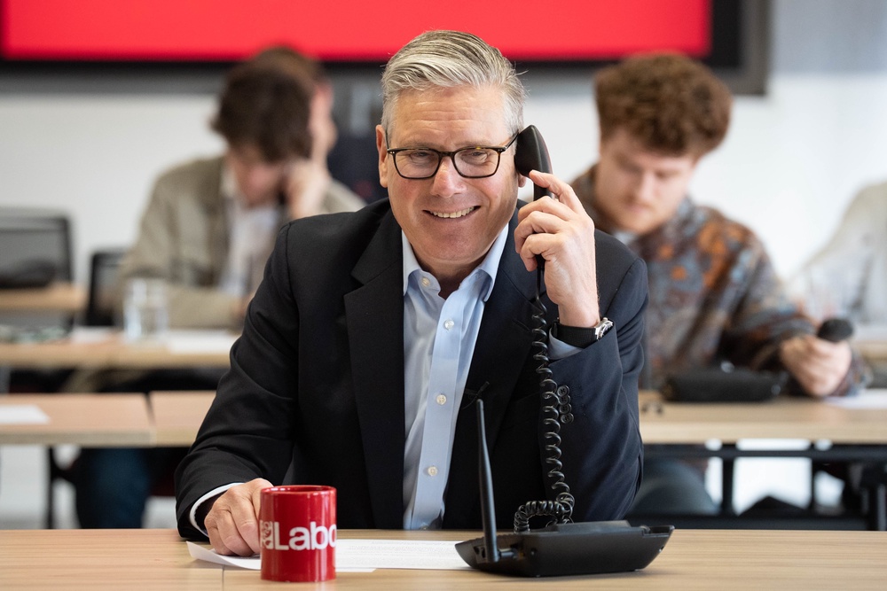 Starmer helps out in the call centre at Labour Party headquarters in London on Wednesday, the last day of campaigning (PA)