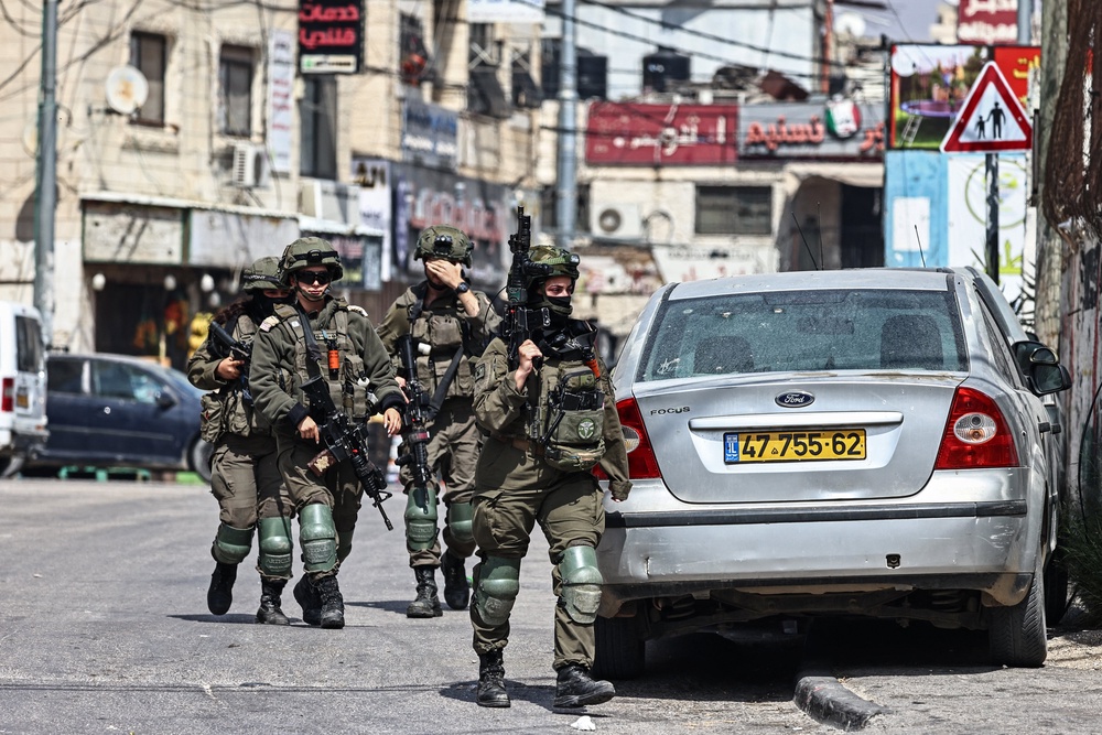 Israeli security forces patrol during a military raid at the Qalandia refugee camp, south of the city of Ramallah, in the Israeli-occupied West Bank, on 6 May 2026 (AFP/Getty)