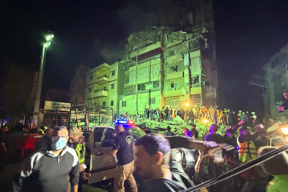 People gather at the site of an Israeli airstrike that targeted Beirut's southern suburbs Haret Hreik neighborhood (AFP/Getty)