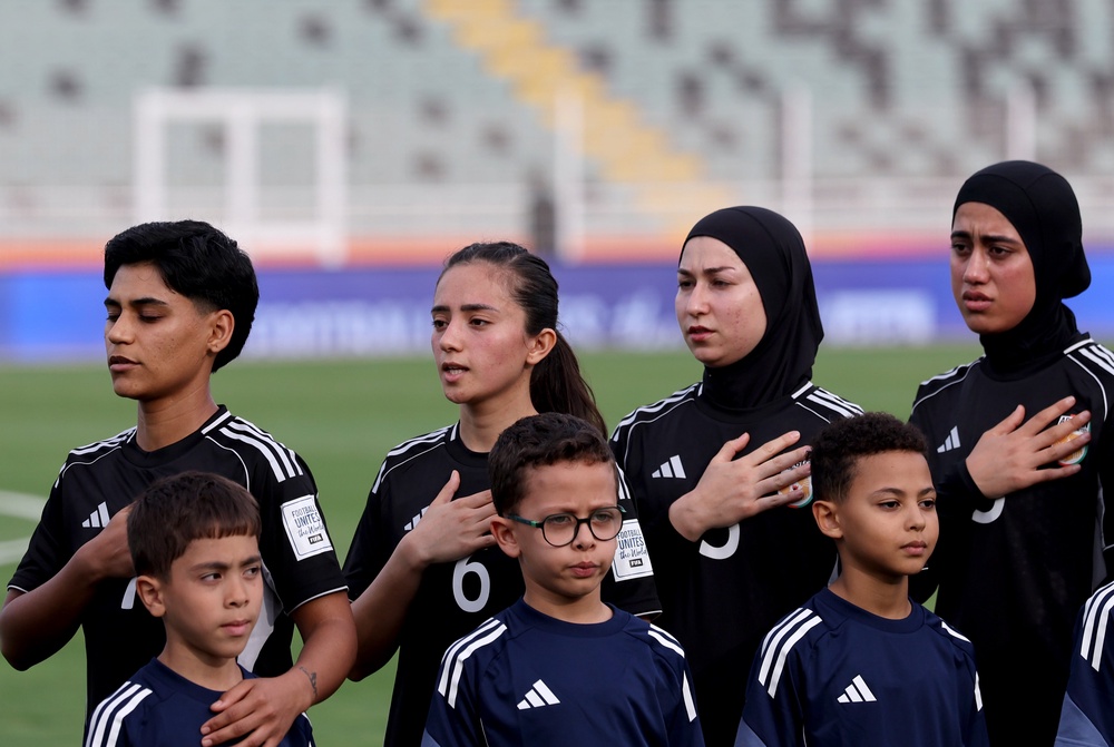 Afghan Women United players sing the national anthem before a match against Chad at Stade Municipal de Berrechid on 26 October 2025 (FIFA via Getty)