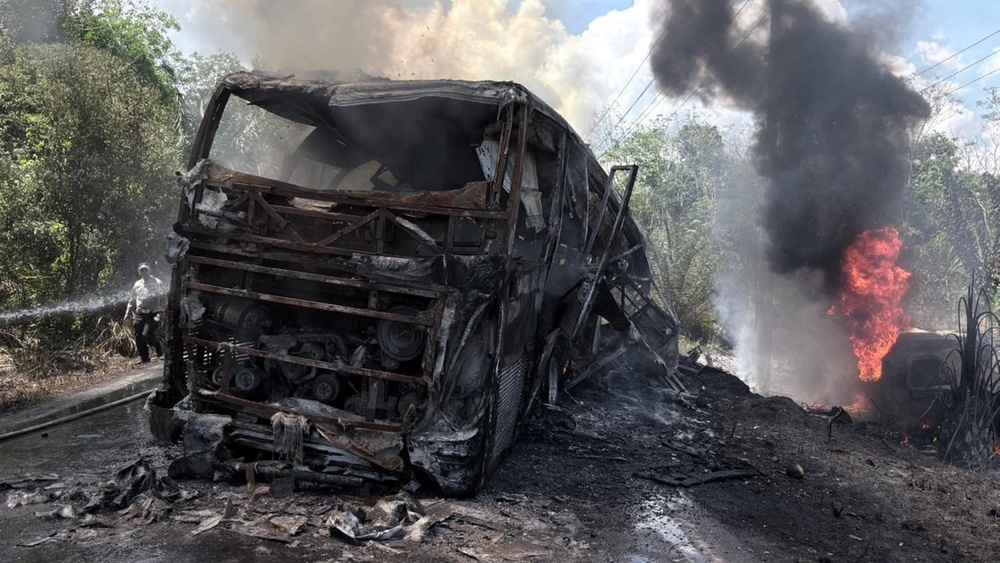In this photo released by South Sumatra Regional Police, a rescuer tries to extinguish fire after a passenger bus collided with a fuel truck in North Musi Rawas regency of South Sumatra province, Indonesia, Wednesday, 6 May 2026 (AP)