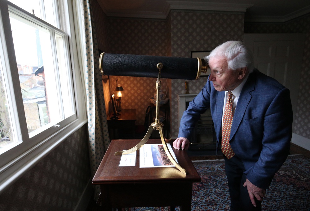 Sir David Attenborough looks through a telescope in JMW Turner's bedroom. (PA)