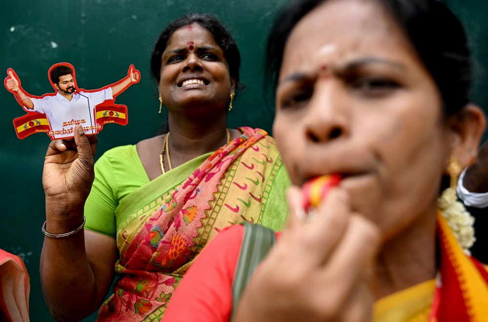 Tamilaga Vettri Kazhagam members celebrate during the counting of votes in Chennai on 4 May 2026 (AFP via Getty)