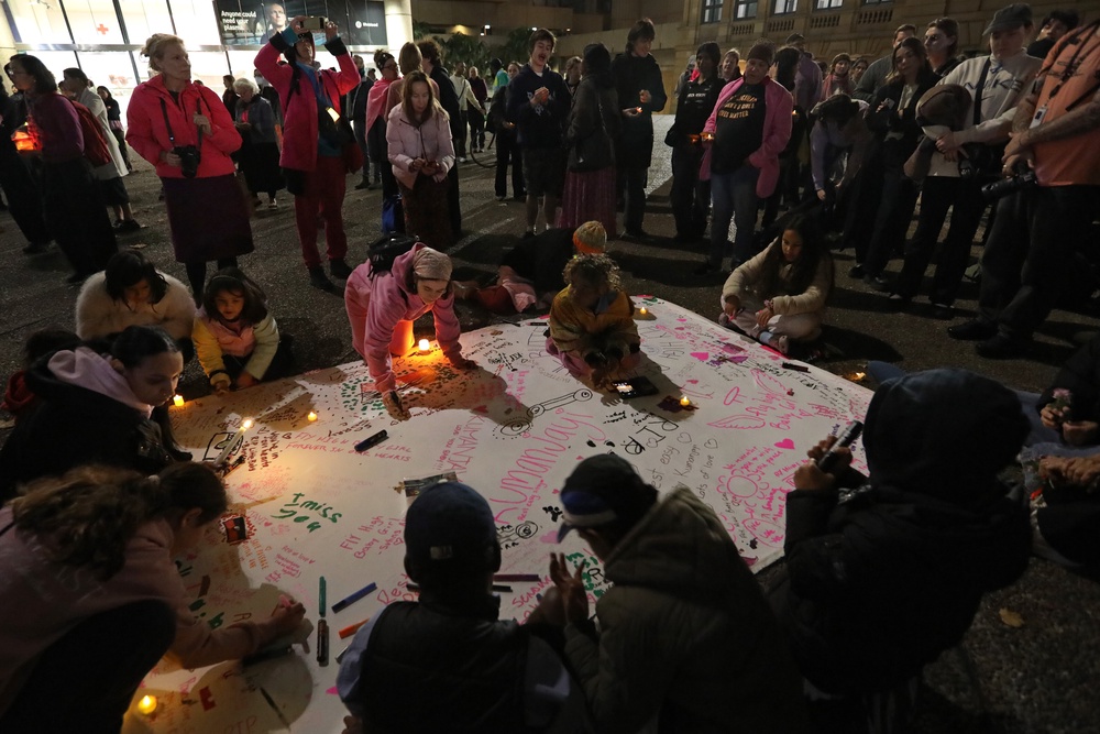 People write messages of love and support during a candlelight vigil in honour of Kumanjayi Little Baby at Town Hall on 7 May 2026 in Sydney, Australia. The vigils follow days of unrest in Alice Springs, where crowds of more than 100 people rioted outside the hospital treating Jefferson Lewis, 47, who has been charged with the murder of the five-year-old Warlpiri girl after her body was found last Thursday, five days after she was reported missing from Old Timers Camp (Getty)