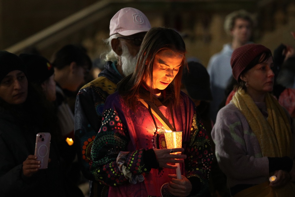 Supporters hold candles as they stand in silence during a vigil in honour of Kumanjayi Little Baby at Town Hall on 7 May 2026 in Sydney, Australia (Getty)