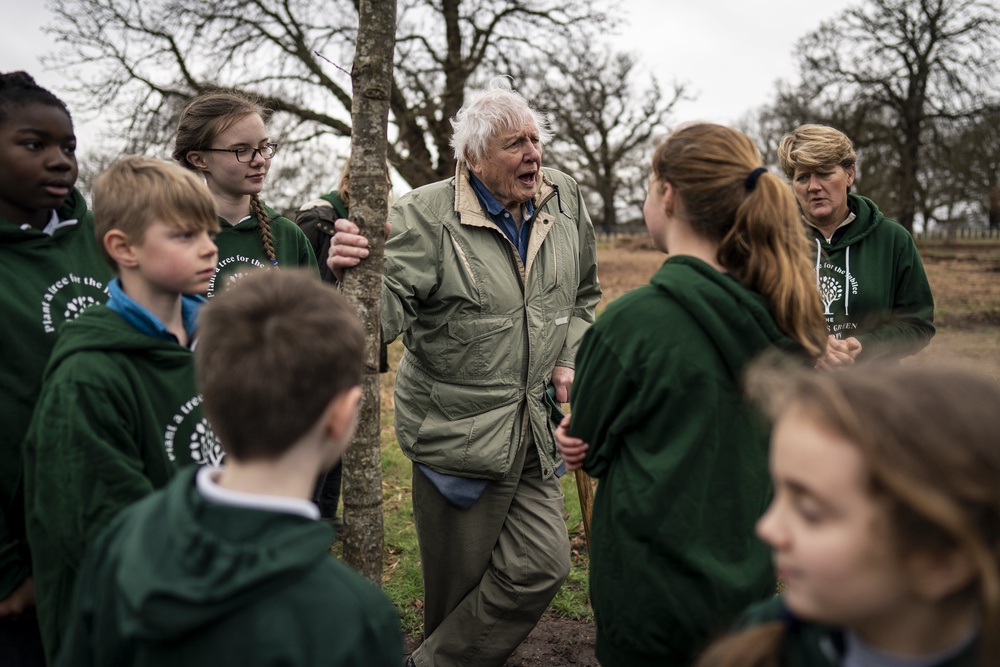 Sir David Attenborough with Clare Balding (rear right) planting a tree in honour of Queen Elizabeth II. (PA)