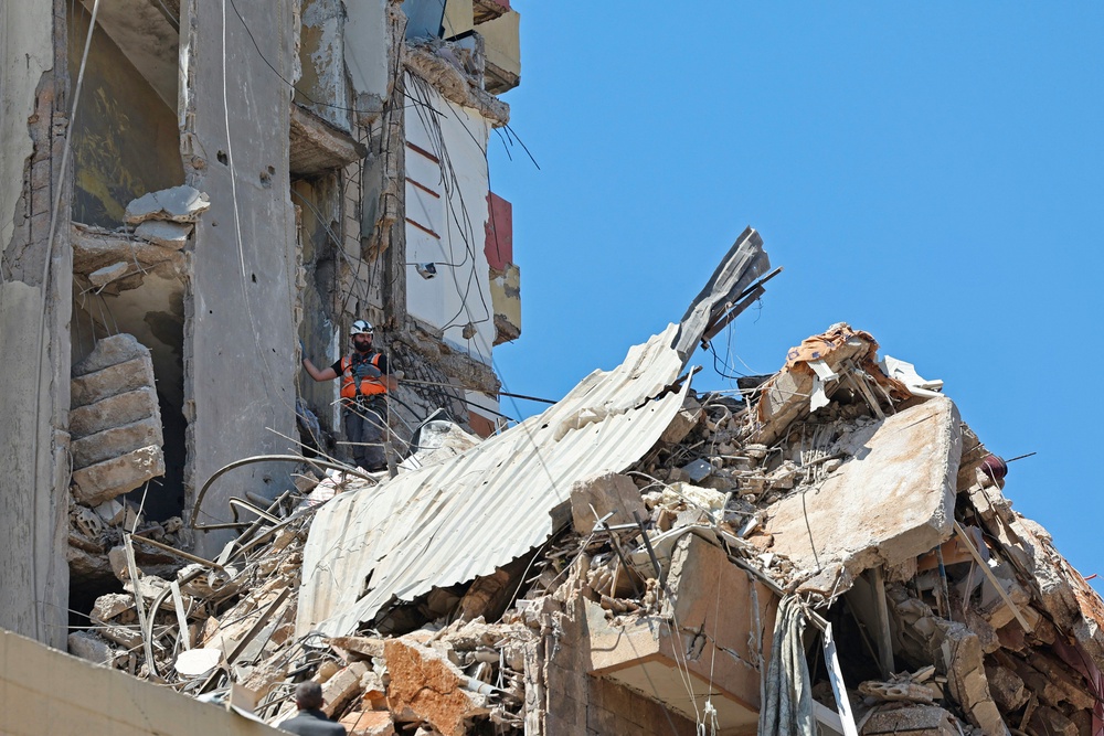 A first responder inspects the rubble of a collapsed building following an Israeli airstrike a day earlier in Beirut's southern suburb of Haret Hreik on May 7, 2026. (AFP/Getty)