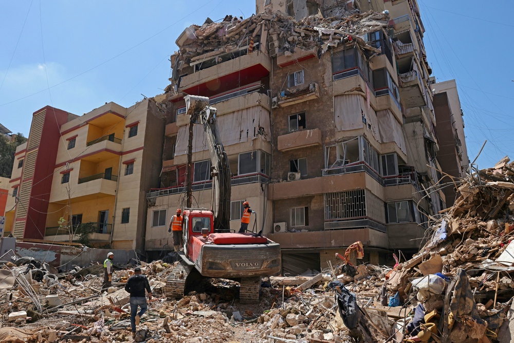 First responders inspect the rubble of a collapsed building following an Israeli airstrike a day earlier in Beirut's southern suburb of Haret Hreik on May 7, 2026. (AFP/Getty)