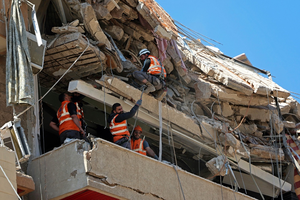 First responders inspect the rubble of a collapsed building following an Israeli airstrike a day earlier in Beirut's southern suburb of Haret Hreik on May 7, 2026. (AFP/Getty)