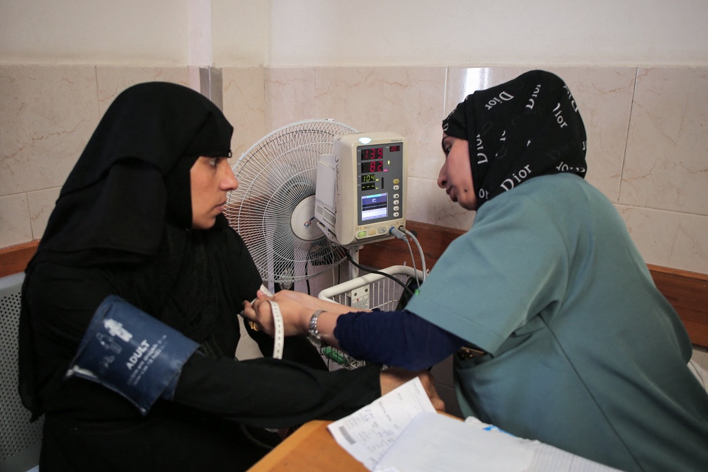 A Palestinian medic examines a woman at a maternity clinic in Khan Younis (AFP via Getty)