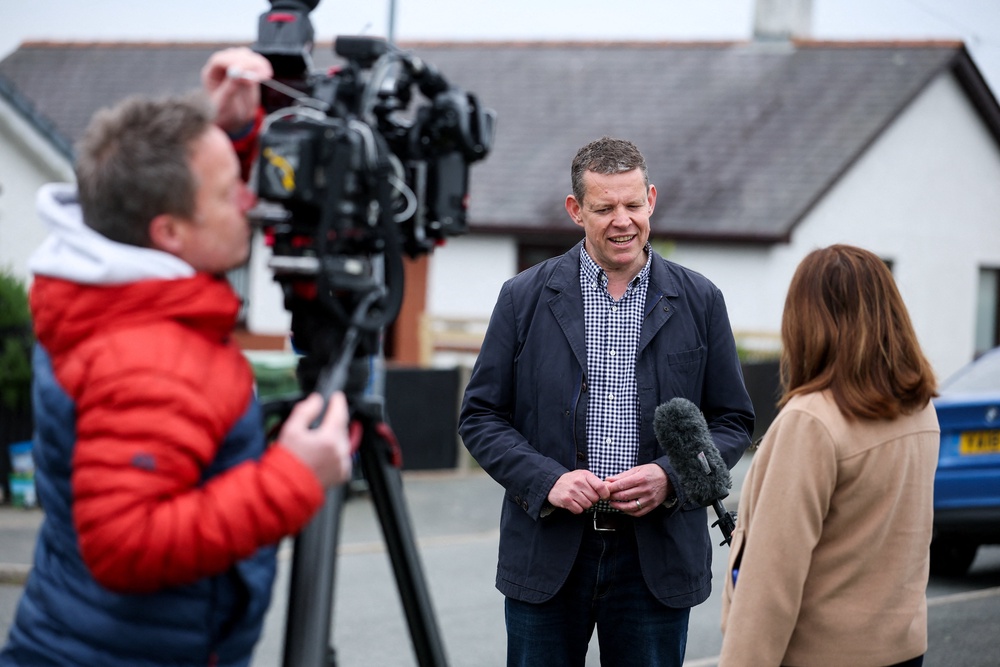 Plaid Cymru leader Rhun ap Iorwerth speaks to the media outside the polling booth (Reuters)