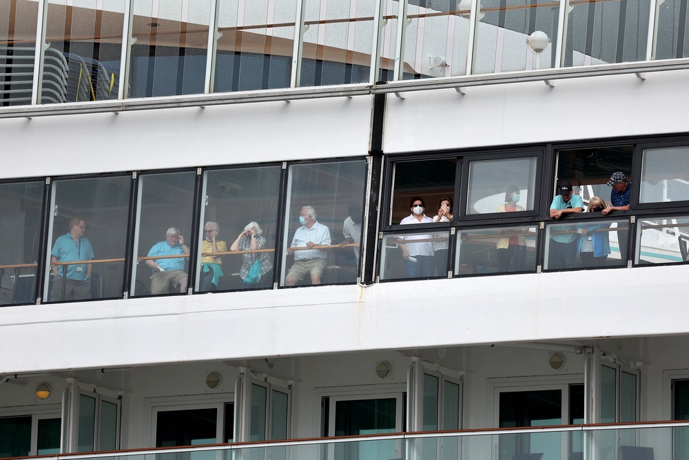 Passengers wait on the Covid-stricken Norwegian Pearl cruise ship at Port Miami in January 2022. Cruise ships helped Covid to spread during the pandemic (Getty)