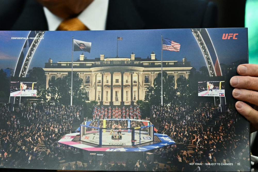 Trump holding a mock-up image of the UFC’s Octagon on the South Lawn (AFP/Getty)