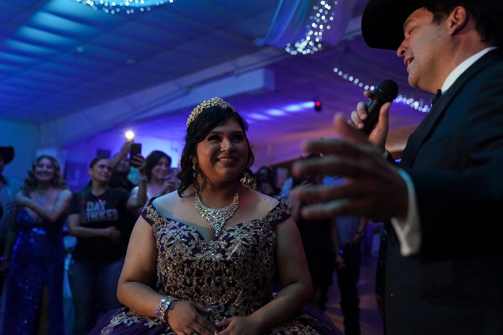 Latin Grammy winner and Democrat candidate for Texas' 15th Congressional District Bobby Pulido, sings to Melanie Nieto, 15, at her quinceanera party in Edinburg, Texas, on March 14, 2026. (Photo by Gabriel V. Cardenas / POOL / AFP via Getty Images) (AFP/Getty)
