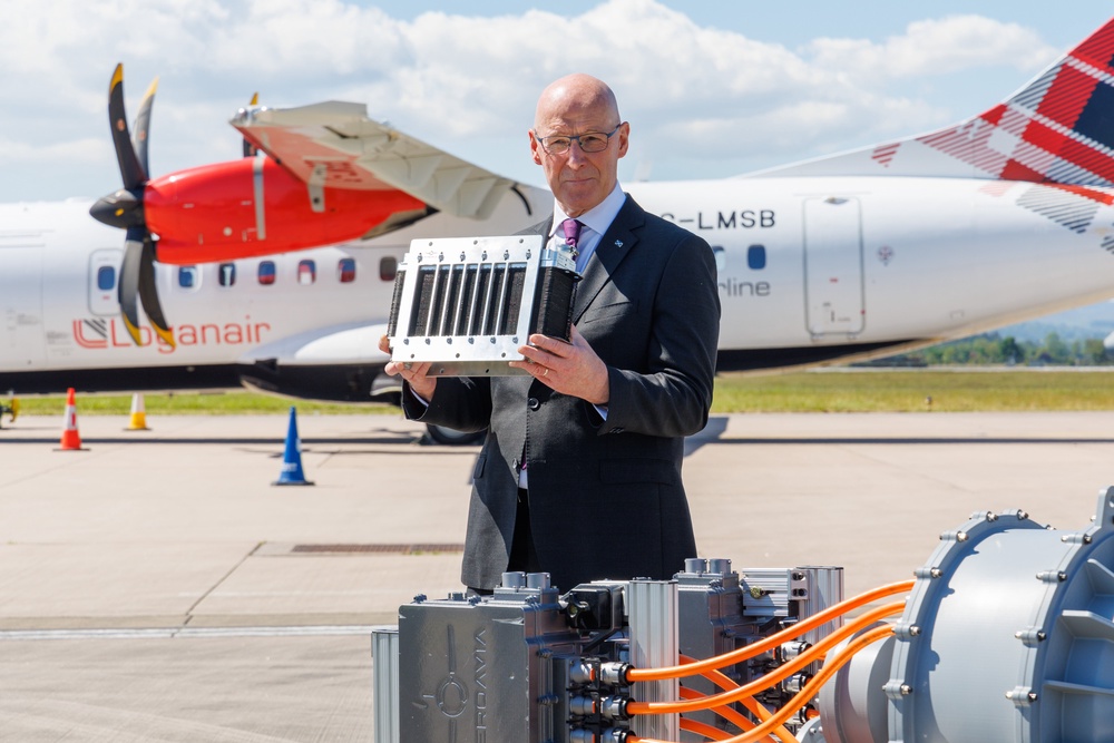 First Minister John Swinney holds a hydrogen cell during a visit to Glasgow airport (Getty)