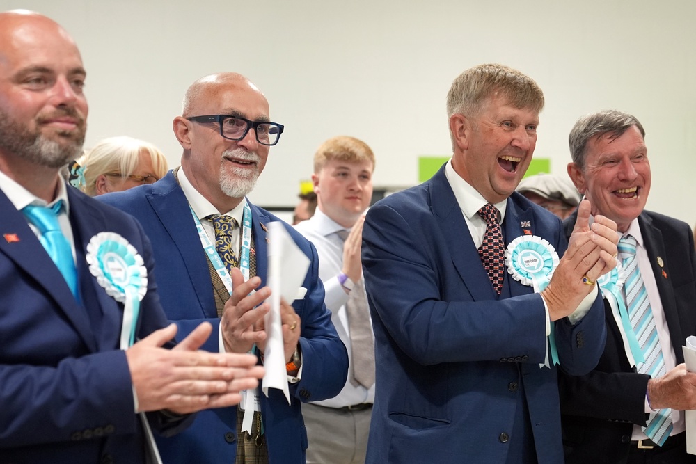 Newly elected Reform councillors celebrate in Essex. The party won 1,454 seats at the recent local elections (PA)