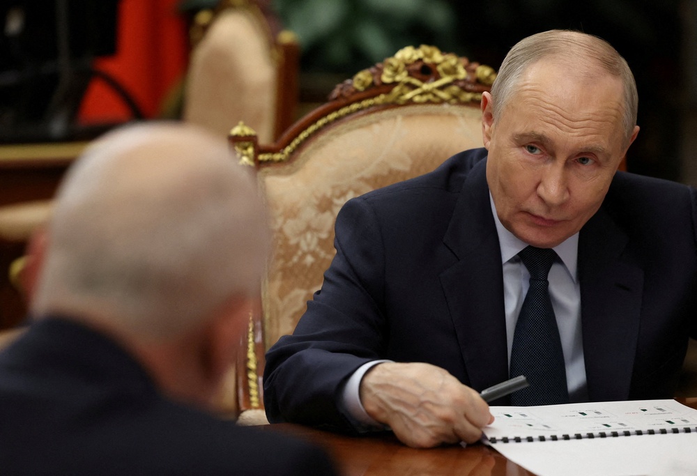 Russia's president Vladimir Putin attends a meeting with CEO of Rostec state corporation Sergei Chemezov in Moscow (Reuters)