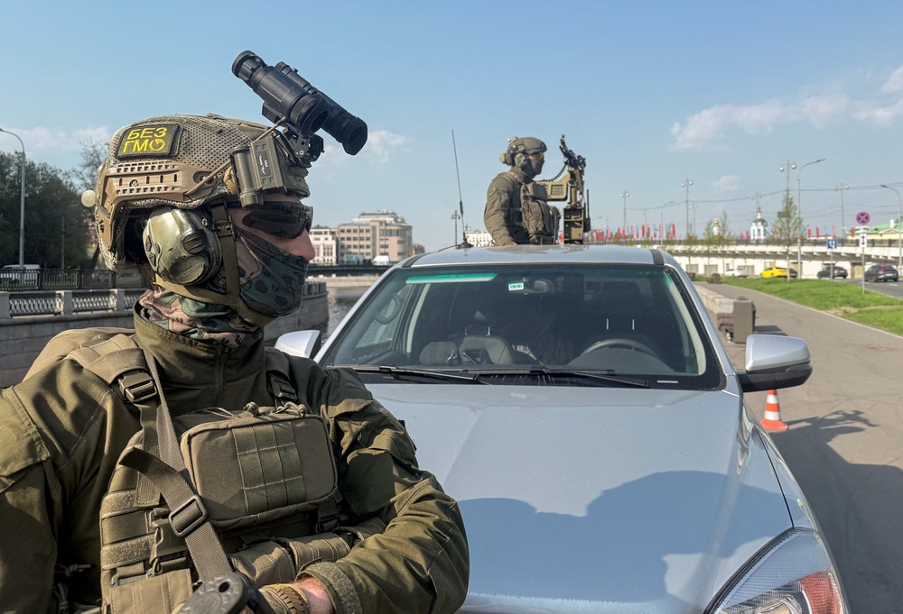 Russian security personnel patrol an area on a pickup truck armed with a machine gun amid increased security measures taken ahead of Victory Day in central Moscow (Reuters)