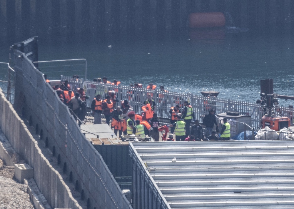 A group of people thought to be migrants at the Border Security Command compound in Dover on Friday morning (Jim Bennett/PA) (PA Wire)