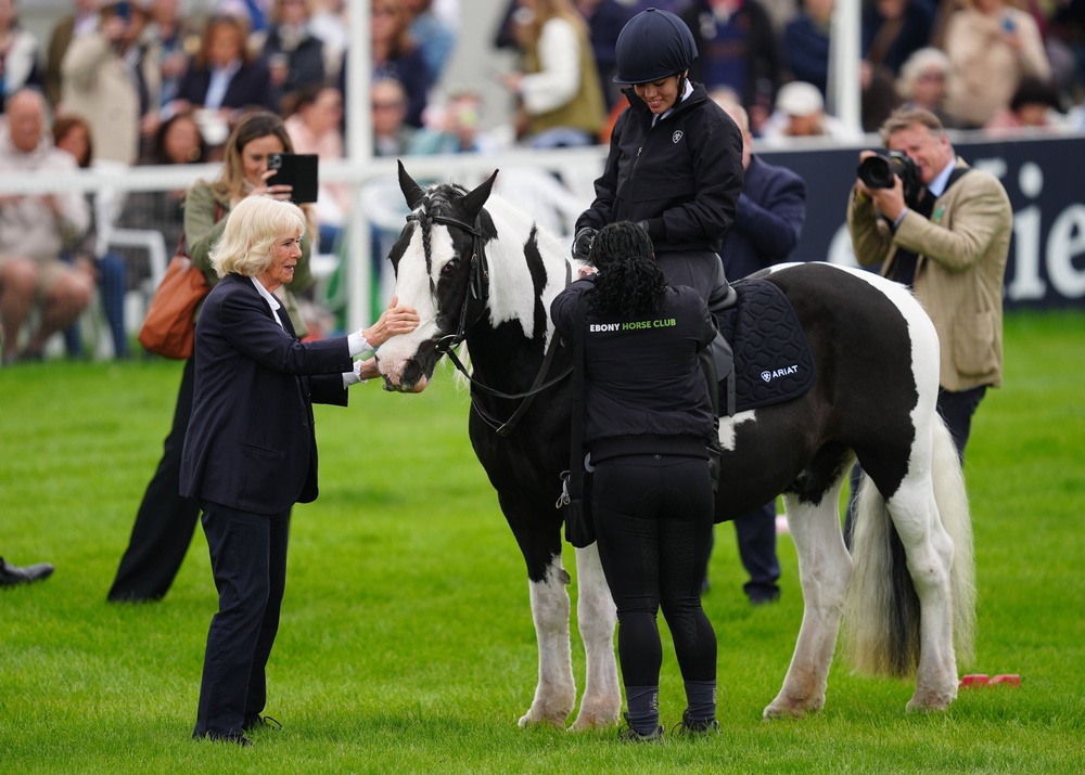 Camilla awarding rosettes to the Ebony Horse Club (David Davies/PA)