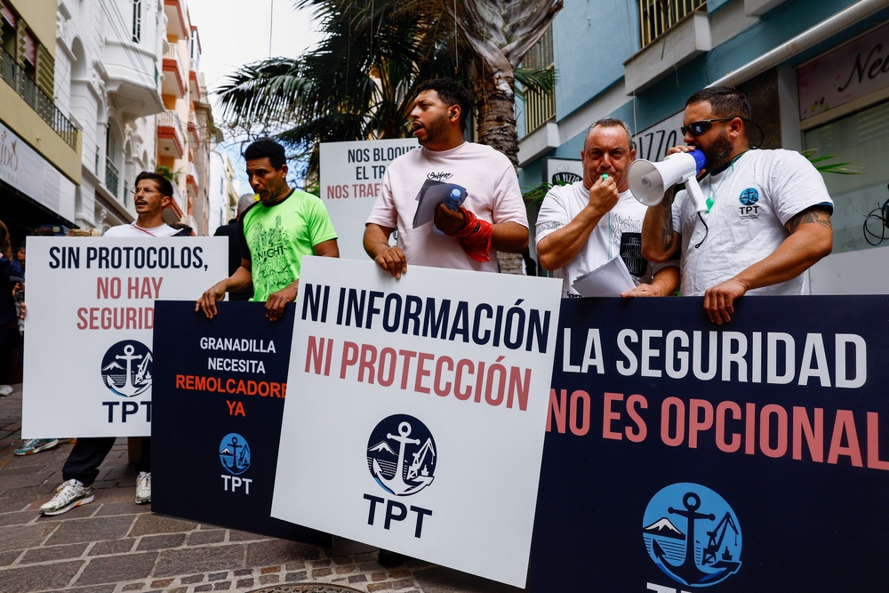 Demonstrators hold placards during a protest by port workers over lack of information ahead of the arrival of the MV Hondius, following a deadly hantavirus outbreak on board the ship, in Santa Cruz de Tenerife, (Reuters)