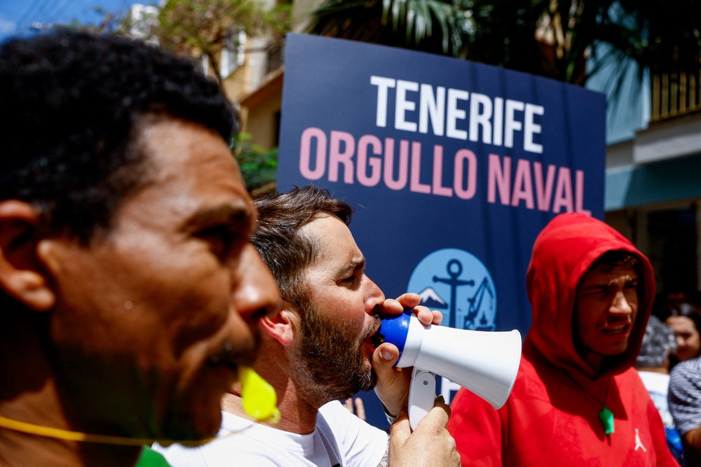 Demonstrators with whistles attend a protest by port workers over lack of information ahead of the arrival of the MV Hondius (Reuters)