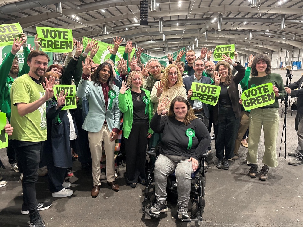 Scottish Green Party candidate Dr Q Manivannan (centre left) celebrates with party colleagues (David Young/PA) (PA Wire)