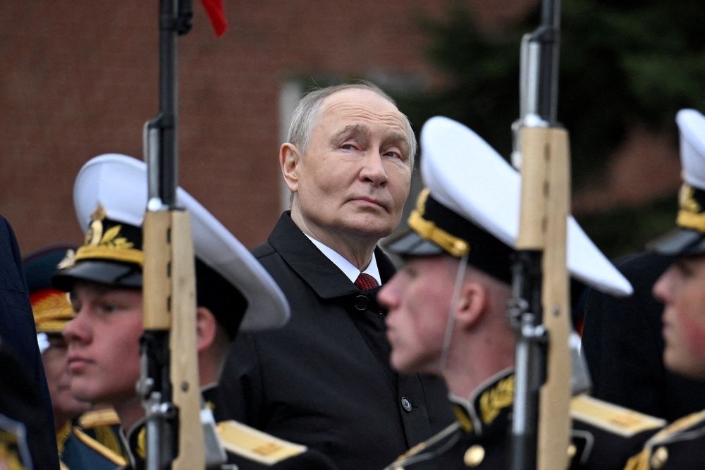 Russian President Vladimir Putin attends a ceremony to lay flowers at the Tomb of the Unknown Soldier (Reuters)