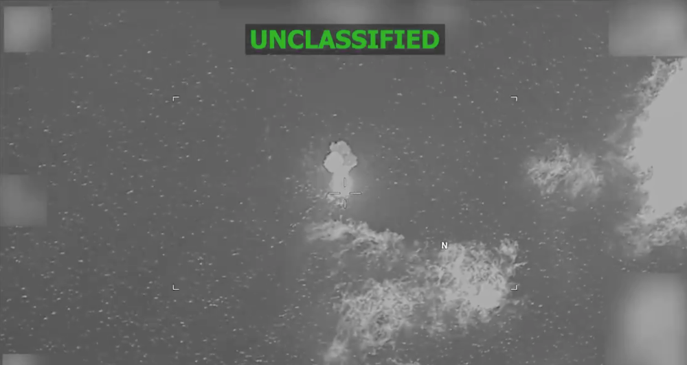 Video posted on social media by U.S. Southern Command shows a black, boat-shaped image before what appears to be an explosion, followed by a column of fire rising from the ocean (U.S. Southern Command)