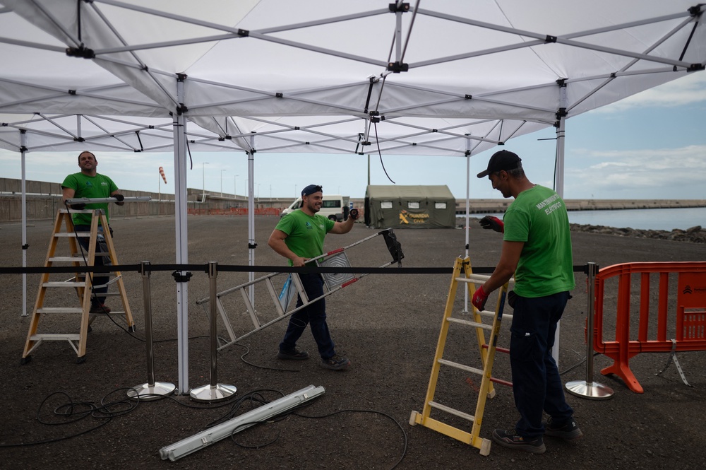 Workers set pole tents prior to the arrival of the Cruise MV Hondius at the port of Granadilla de Abona on the island of Tenerife in Spain's Canary Islands on 9 May (AFP/Getty)