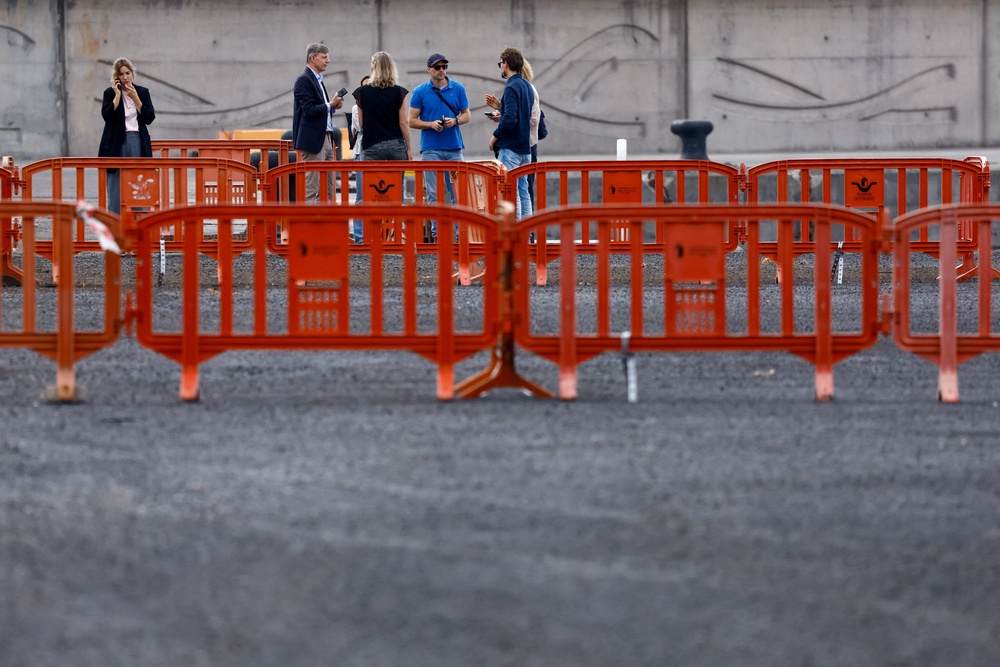 Workers prepare security measures at the port of Granadilla de Abona (Reuters)