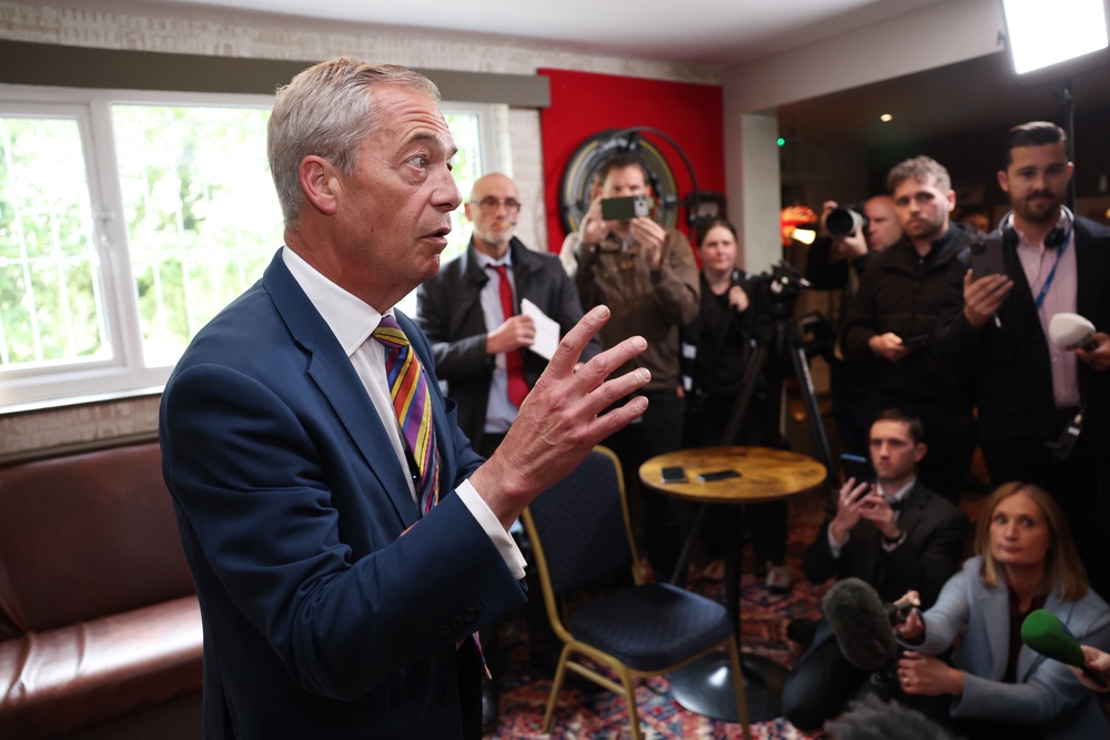 Reform UK leader Nigel Farage speaks to media at The Dam Bar and Grill in St Helens (Getty)