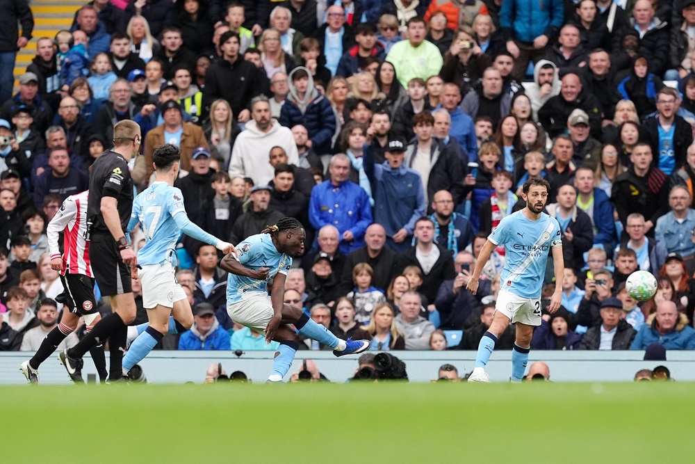 Jeremy Doku, centre, scores Manchester City’s first goal against Brentford (Martin Rickett/PA)