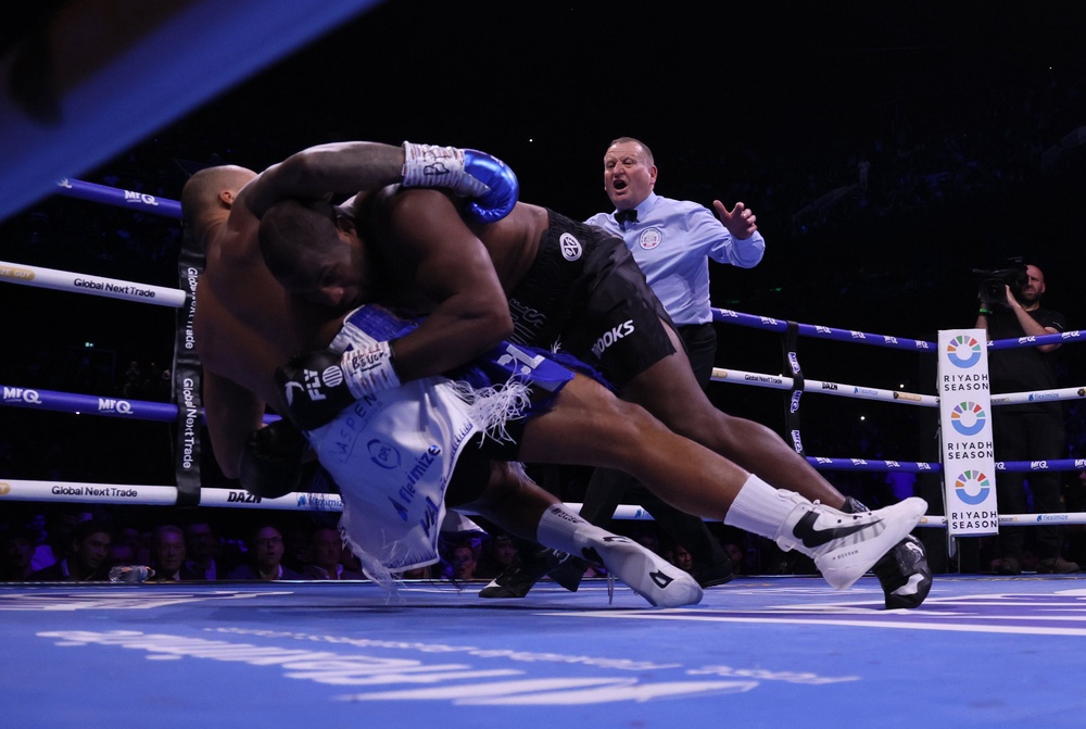 Dubois (right) celebrated after the fight was stopped in the 11th round (Richard Sellers/PA) (PA Wire)