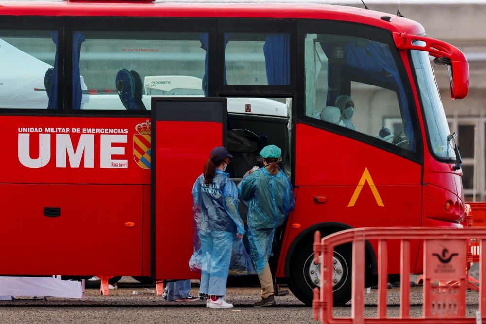 Passengers board a bus for evacuation (Reuters)